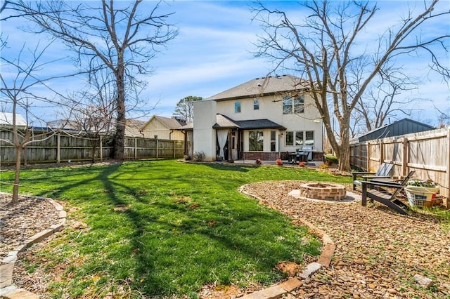 113 SE F St, Bentonville, AR 72712 - rear view of property with a yard, a fire pit, a fenced backyard, and stucco siding