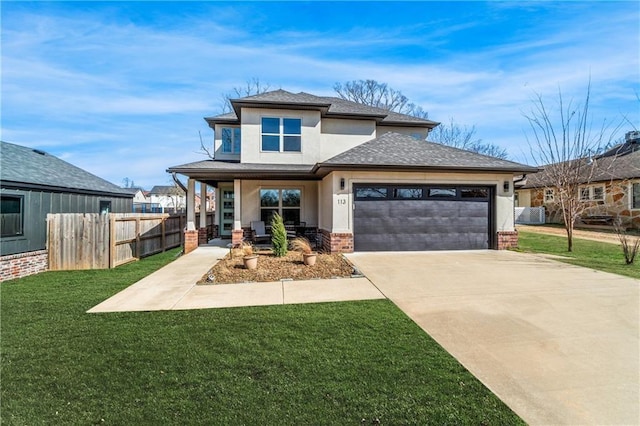 113 SE F St, Bentonville, AR 72712 - prairie-style home featuring a garage, a front lawn, fence, a porch, and driveway
