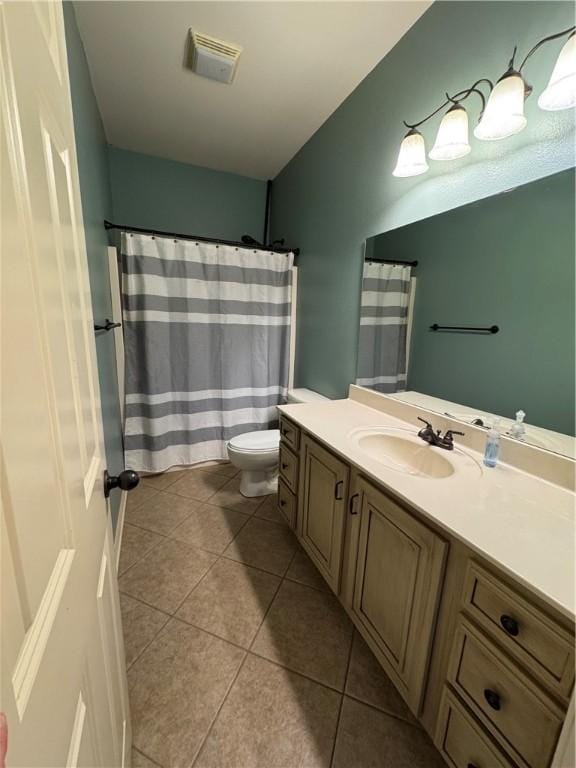 bathroom with vanity, toilet, tile patterned floors, and visible vents