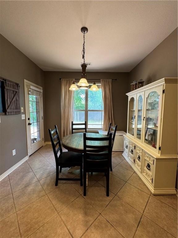 dining area with baseboards and light tile patterned floors