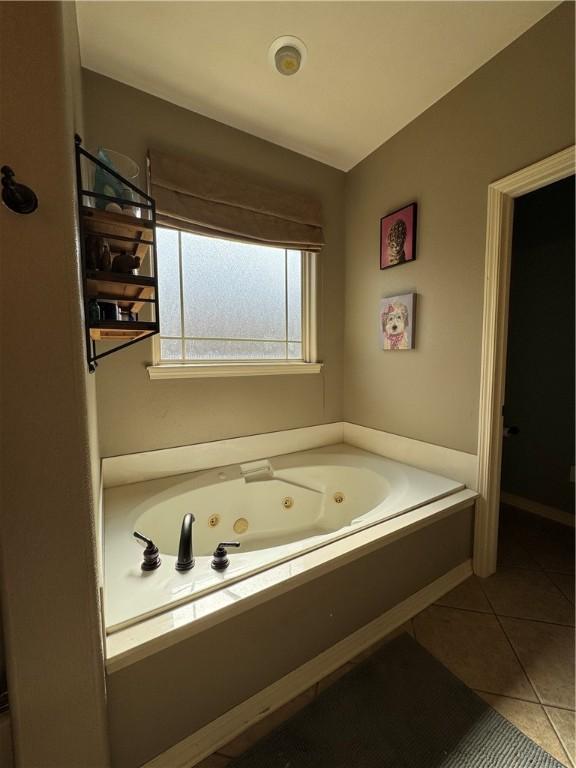 bathroom featuring a jetted tub and tile patterned floors