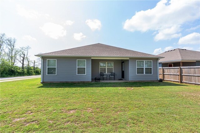 3715 S 1st Pl, Rogers, AR 72758 - rear view of property with a lawn, a patio area, and fence