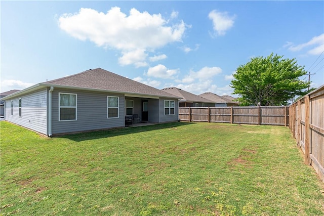 3715 S 1st Pl, Rogers, AR 72758 - rear view of property featuring a lawn, a fenced backyard, and a patio