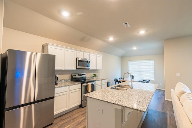 3715 S 1st Pl, Rogers, AR 72758 - kitchen with white cabinetry, appliances with stainless steel finishes, a sink, and wood finished floors