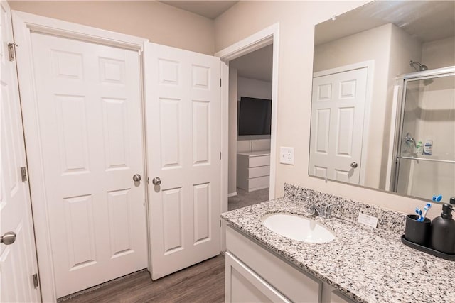 3715 S 1st Pl, Rogers, AR 72758 - bathroom featuring vanity, wood finished floors, and a stall shower
