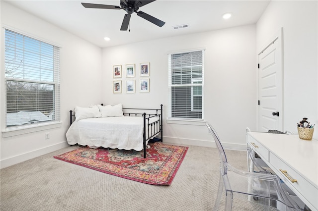 bedroom featuring baseboards, light colored carpet, recessed lighting, and visible vents