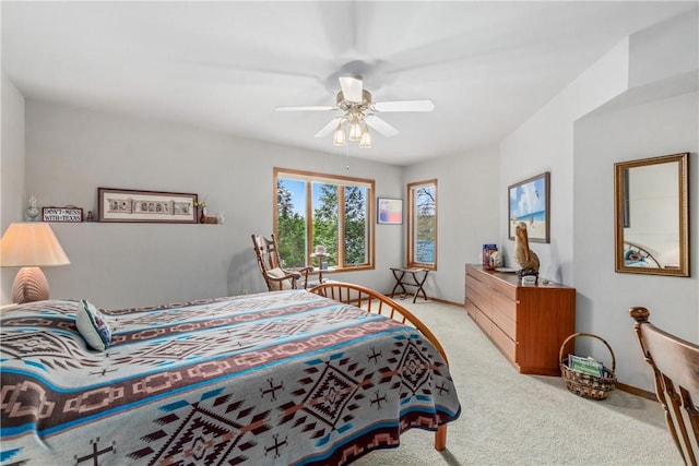 bedroom featuring baseboards, a ceiling fan, and light colored carpet
