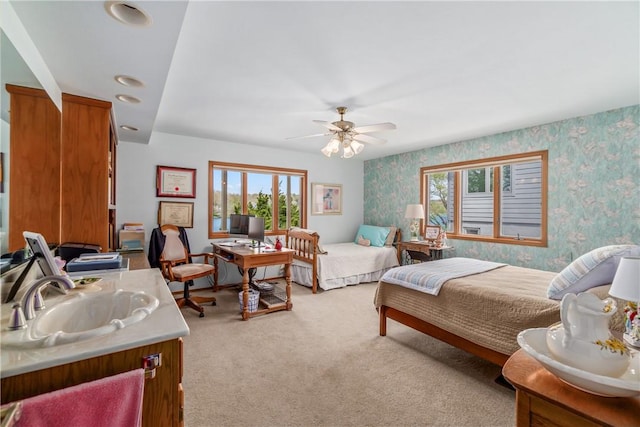 bedroom featuring ceiling fan, a sink, wallpapered walls, light carpet, and recessed lighting