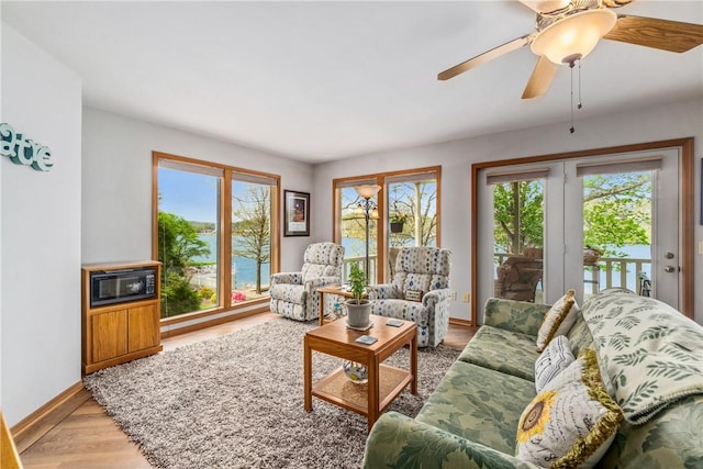 50 Churchill Dr, Bella Vista, AR 72715 - living area featuring a wealth of natural light, baseboards, a ceiling fan, and light wood-type flooring