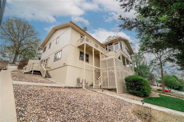 exterior space featuring a balcony and stairway