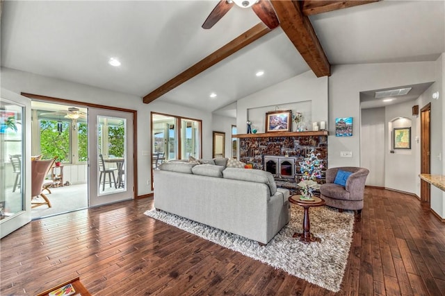 living area featuring a healthy amount of sunlight, vaulted ceiling with beams, a ceiling fan, and dark wood-style flooring