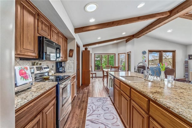50 Churchill Dr, Bella Vista, AR 72715 - kitchen featuring a sink, stainless steel appliances, lofted ceiling with beams, brown cabinets, and recessed lighting