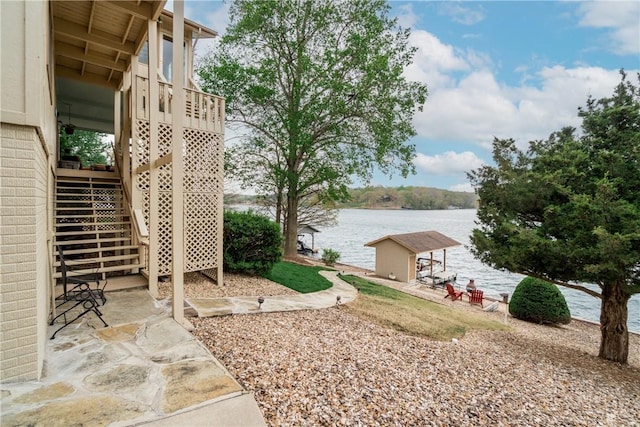 view of yard with stairs and a water view