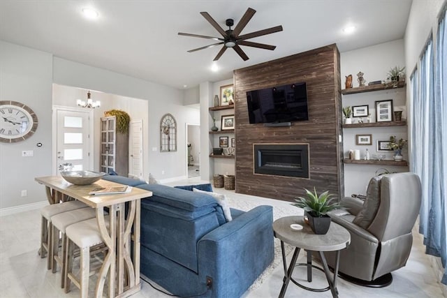living area featuring recessed lighting, baseboards, ceiling fan with notable chandelier, and a large fireplace