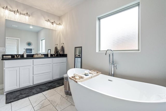 bathroom featuring double vanity, a sink, a soaking tub, and marble finish floor