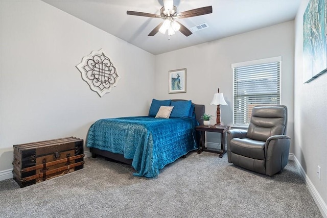 carpeted bedroom featuring ceiling fan, visible vents, and baseboards