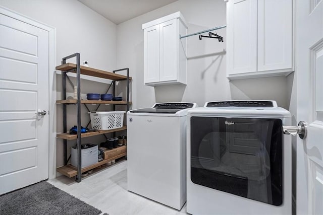 laundry room featuring independent washer and dryer and cabinet space