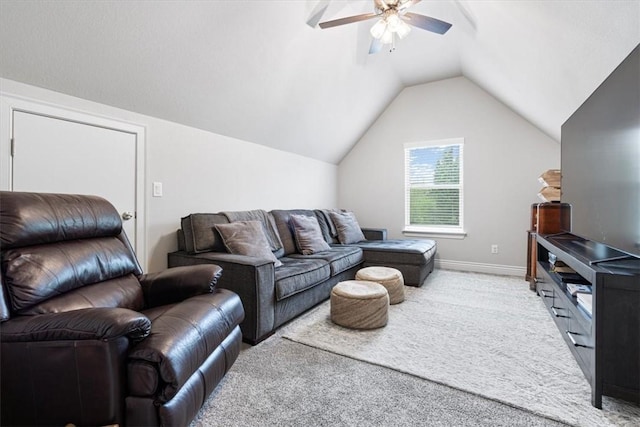 living area featuring ceiling fan, lofted ceiling, baseboards, and carpet