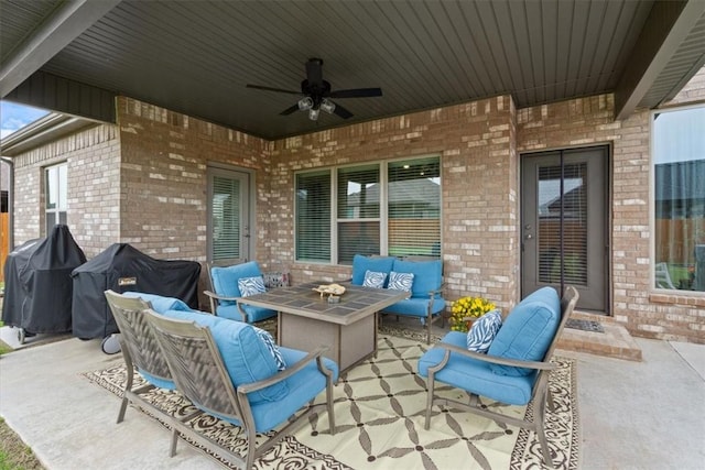 view of patio with grilling area, a ceiling fan, and an outdoor hangout area