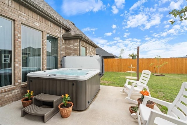 view of patio with a fenced backyard and a hot tub