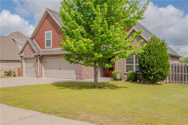 view of front of house with brick siding, fence, driveway, and a front lawn