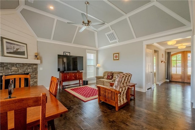living area featuring ceiling fan, a fireplace, high vaulted ceiling, wood finished floors, and visible vents