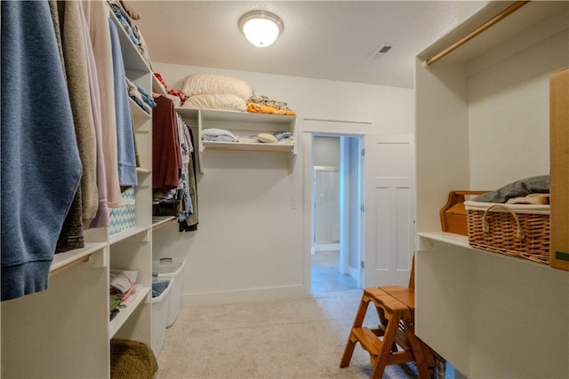 spacious closet featuring visible vents and carpet