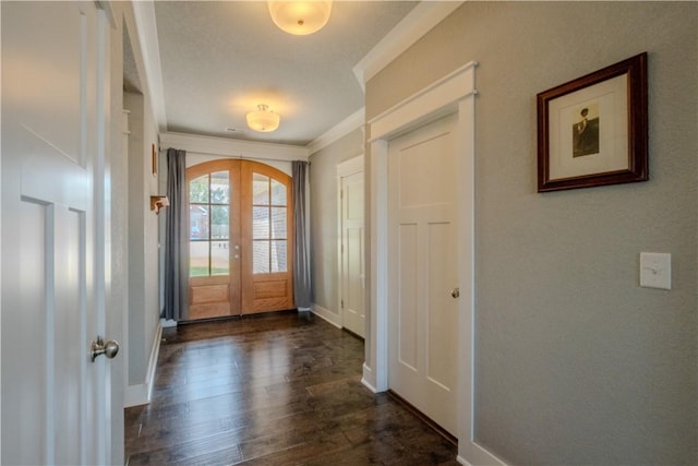 entryway featuring french doors, ornamental molding, dark wood-style flooring, and baseboards