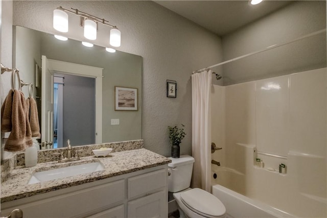 bathroom featuring vanity, a textured wall, toilet, and shower / tub combo with curtain
