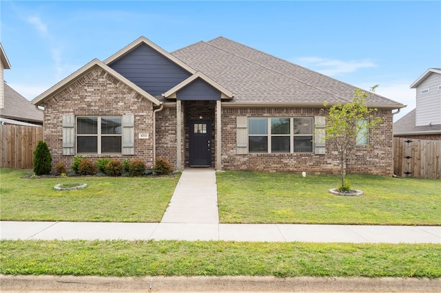 4311 SW Pawhuska St, Bentonville, AR 72713 - view of front of home featuring fence, a front yard, and brick siding