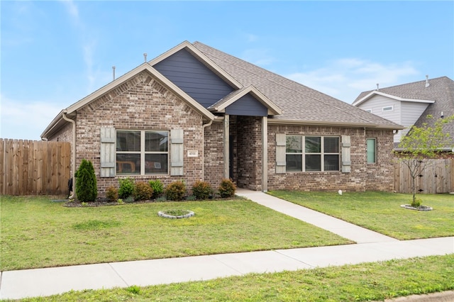 4311 SW Pawhuska St, Bentonville, AR 72713 - view of front of house with brick siding, a front lawn, and fence