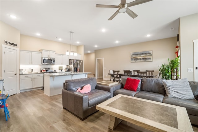 4311 SW Pawhuska St, Bentonville, AR 72713 - living area featuring recessed lighting, a ceiling fan, and light wood finished floors
