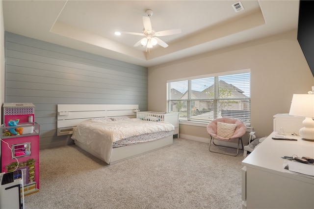4311 SW Pawhuska St, Bentonville, AR 72713 - bedroom with light colored carpet, visible vents, a raised ceiling, baseboards, and wooden walls