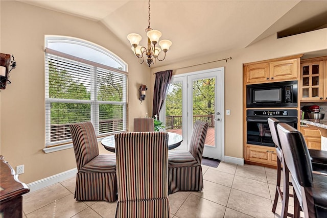 dining space featuring a chandelier, plenty of natural light, and lofted ceiling