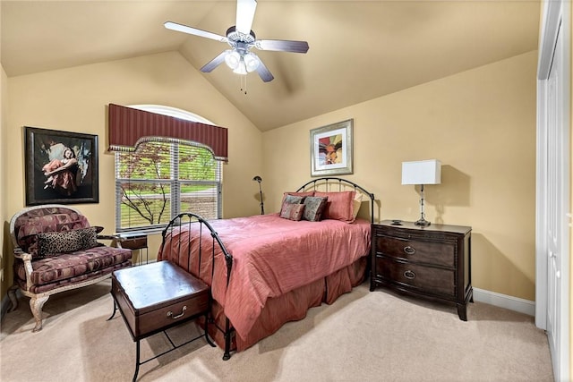 bedroom with baseboards, light carpet, a ceiling fan, and lofted ceiling