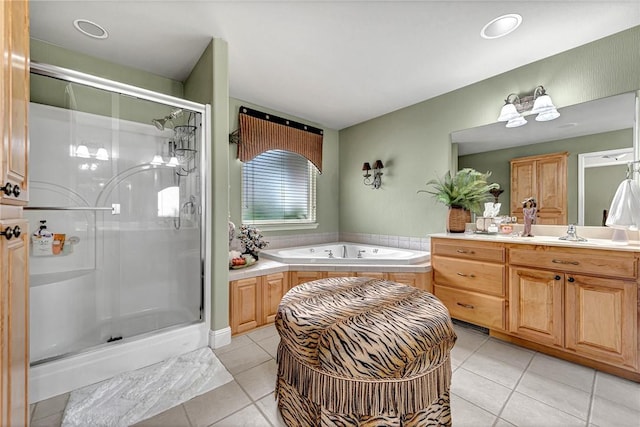 bathroom featuring a stall shower, tile patterned floors, a garden tub, and vanity