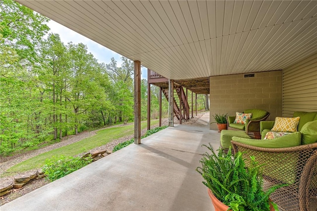 view of patio with stairs and an outdoor living space
