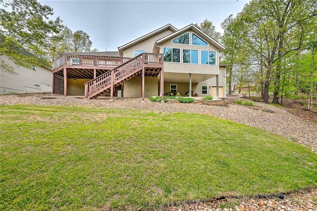 back of property with stairs, a wooden deck, and a yard