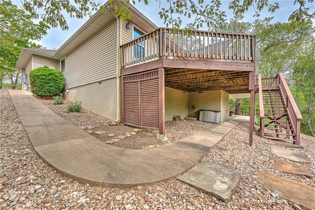 view of home's exterior with stairs, a deck, and cooling unit
