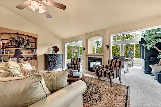 living area featuring carpet, a multi sided fireplace, a wealth of natural light, and vaulted ceiling