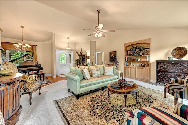 living room featuring baseboards, ceiling fan with notable chandelier, carpet flooring, and lofted ceiling