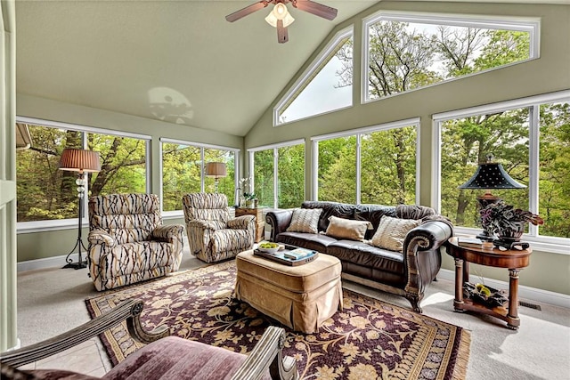 sunroom featuring carpet flooring, baseboards, and high vaulted ceiling