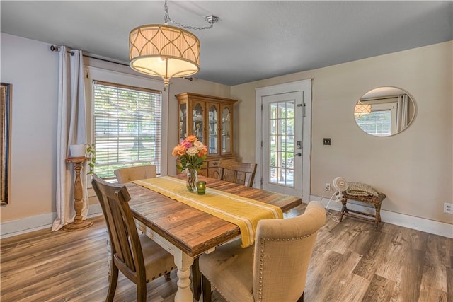 302 4th Ave, Gravette, AR 72736 - dining space with baseboards, plenty of natural light, and wood finished floors