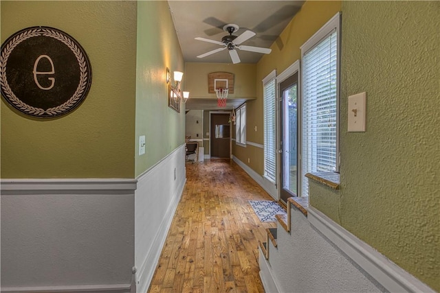302 4th Ave, Gravette, AR 72736 - hallway featuring a textured wall and hardwood / wood-style floors
