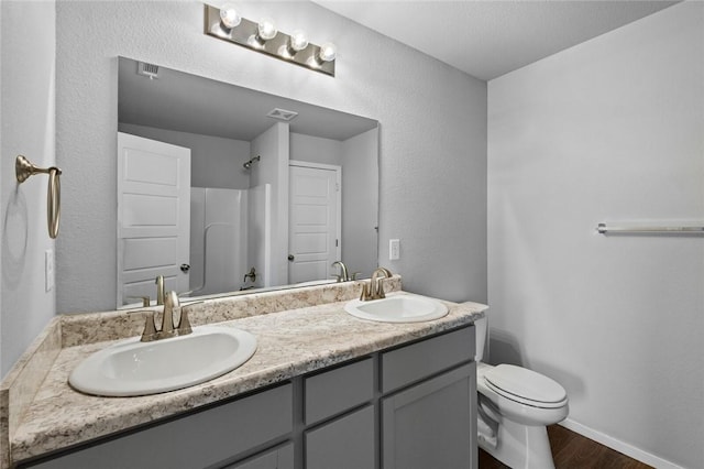 988 E Bunting St, Fayetteville, AR 72701 - full bath featuring a sink, walk in shower, toilet, and wood finished floors