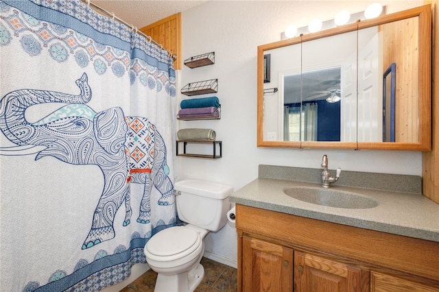 bathroom with vanity, baseboards, a shower with shower curtain, and toilet