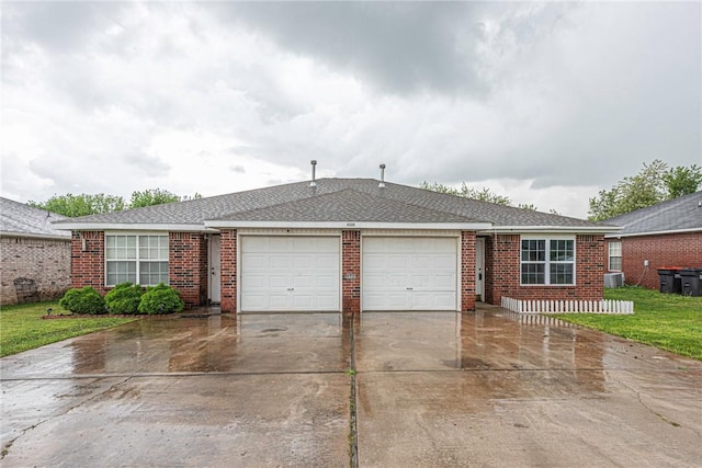ranch-style house with a front lawn, brick siding, a garage, concrete driveway, and cooling unit