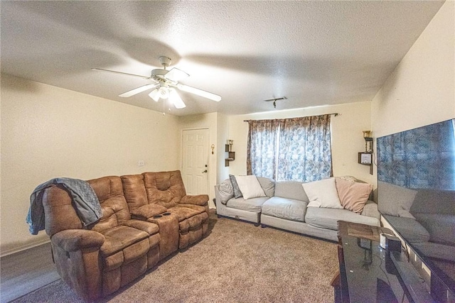 carpeted living area with a textured ceiling and ceiling fan
