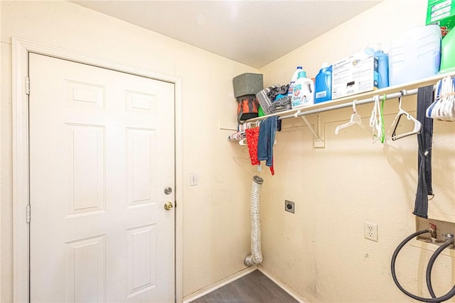 clothes washing area with laundry area, hookup for a washing machine, electric dryer hookup, baseboards, and wood finished floors