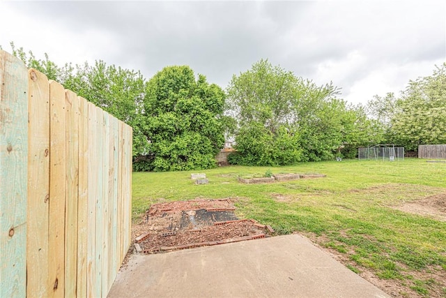 view of yard with fence and a vegetable garden